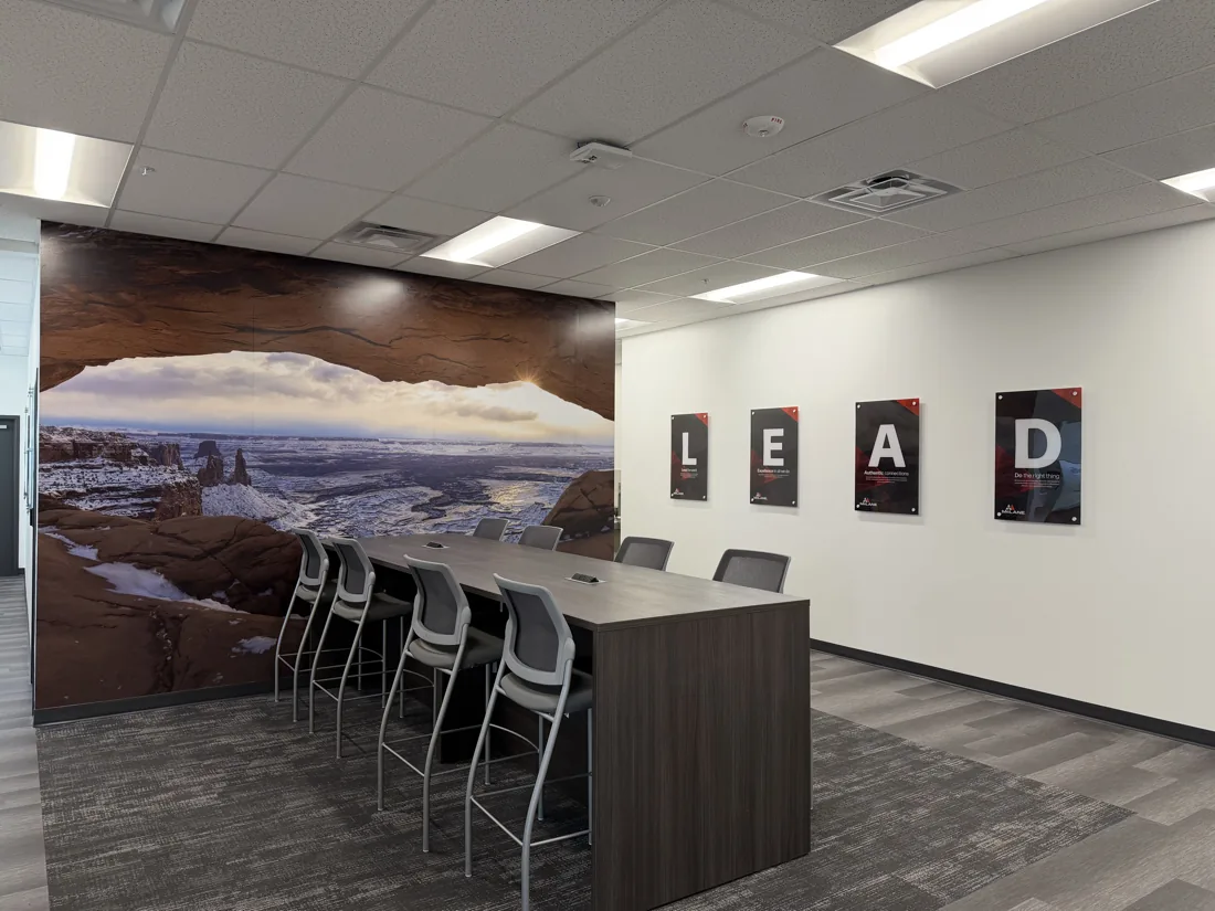 Full-wall Mesa Arch mural and printed acrylic LEAD panels in a McLane office, printed and installed by VE Signs